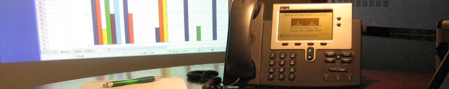 Bendigo Audio Visual - Image of Boardroom table with phone and screen in background.